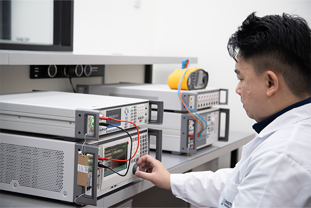 A Unitest technician working with rack-mounted test & measurement instruments
